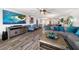 Bright living room with comfortable seating and large TV at 1591 Gulf Blvd # 504S, Clearwater Beach, FL 33767