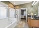 Main bathroom with a large garden tub, separate shower, and bedroom view at 16020 Starling Crossing Dr, Lithia, FL 33547