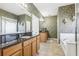 Elegant bathroom with granite countertops, double sinks, and a garden tub at 16020 Starling Crossing Dr, Lithia, FL 33547