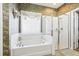 Bathroom with soaking tub, shower, and patterned wallpaper at 16020 Starling Crossing Dr, Lithia, FL 33547