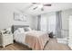 Primary bedroom featuring a queen bed, window, and ceiling fan at 16020 Starling Crossing Dr, Lithia, FL 33547