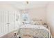 Bedroom with white metal bed frame and soft, floral decor at 16020 Starling Crossing Dr, Lithia, FL 33547