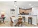 Charming dining area with a table for four and a view into the kitchen at 16020 Starling Crossing Dr, Lithia, FL 33547