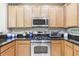 Modern kitchen with stainless steel appliances and granite countertops at 16020 Starling Crossing Dr, Lithia, FL 33547