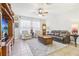 Spacious living room with leather seating, a large TV, and plenty of natural light at 16020 Starling Crossing Dr, Lithia, FL 33547