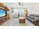 Spacious living room with leather seating, a large TV, and plenty of natural light at 16020 Starling Crossing Dr, Lithia, FL 33547