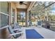Relaxing screened porch with patio furniture and ceiling fan at 16020 Starling Crossing Dr, Lithia, FL 33547