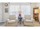 Cozy sitting area with two armchairs and a side table at 16020 Starling Crossing Dr, Lithia, FL 33547