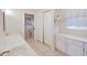 Clean bathroom with double vanity, toilet, and sliding door to shower at 1906 Wolf Laurel Dr, Sun City Center, FL 33573