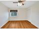 Bright bedroom with wood-look flooring and ceiling fan at 1906 Wolf Laurel Dr, Sun City Center, FL 33573