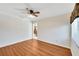 Spacious bedroom featuring wood-look laminate flooring and a ceiling fan at 1906 Wolf Laurel Dr, Sun City Center, FL 33573