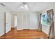 Well-lit bedroom with wood flooring and a ceiling fan at 1906 Wolf Laurel Dr, Sun City Center, FL 33573