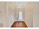 Bright entryway with wood-look floors, white closets, and chandelier at 1906 Wolf Laurel Dr, Sun City Center, FL 33573