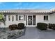 Front entrance with decorative screen door and landscaping at 1906 Wolf Laurel Dr, Sun City Center, FL 33573