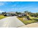 Front view of a single-story house with a paved driveway at 1906 Wolf Laurel Dr, Sun City Center, FL 33573