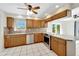 Well-equipped kitchen featuring wood cabinets and stainless steel appliances at 1906 Wolf Laurel Dr, Sun City Center, FL 33573