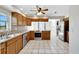 Kitchen with wood cabinets, stainless steel appliances, and tile floor at 1906 Wolf Laurel Dr, Sun City Center, FL 33573