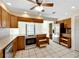 Kitchen boasts wood cabinets, stainless steel appliances, and tile floors at 1906 Wolf Laurel Dr, Sun City Center, FL 33573