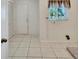 Bright laundry room with tile floors, built-in shelving, and exterior access at 1906 Wolf Laurel Dr, Sun City Center, FL 33573