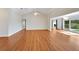 Open living room with hardwood floors, vaulted ceiling, and access to the backyard at 1906 Wolf Laurel Dr, Sun City Center, FL 33573