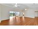 Bright and airy living room with hardwood floors and a view of the kitchen at 1906 Wolf Laurel Dr, Sun City Center, FL 33573