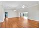 Large living area with wood flooring, high ceilings, and ceiling fans at 1906 Wolf Laurel Dr, Sun City Center, FL 33573