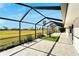 Expansive screened patio overlooking a lush green space at 1906 Wolf Laurel Dr, Sun City Center, FL 33573