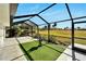 Relaxing screened patio with artificial turf and a water fountain at 1906 Wolf Laurel Dr, Sun City Center, FL 33573