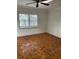 Bedroom featuring wood floors, plantation shutters, and a ceiling fan at 200 Carmona Ne Way, St Petersburg, FL 33704