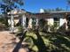 Pink brick house with a circular driveway and manicured lawn at 200 Carmona Ne Way, St Petersburg, FL 33704