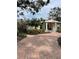 Pink brick home with a paved driveway and mature landscaping at 200 Carmona Ne Way, St Petersburg, FL 33704