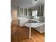 Bright kitchen with white cabinets, a curved countertop, and wood floors at 200 Carmona Ne Way, St Petersburg, FL 33704