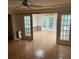 Living room with parquet floors, ceiling fan, and French doors leading to a sunroom at 200 Carmona Ne Way, St Petersburg, FL 33704