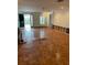 Spacious living room with parquet wood floors, fireplace, and front entry access at 200 Carmona Ne Way, St Petersburg, FL 33704