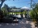 Relaxing patio area with wicker furniture and a striped umbrella at 200 Carmona Ne Way, St Petersburg, FL 33704