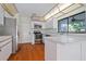 White kitchen with stainless steel appliances and an island counter top at 21015 4Th St, Land O Lakes, FL 34638