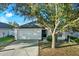 Two-story house with a white exterior, attached garage, and landscaping at 24643 Portofino Dr, Lutz, FL 33559