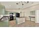 Eat-in kitchen with green cabinets, granite counters and island at 24643 Portofino Dr, Lutz, FL 33559