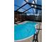 Enclosed kidney-shaped pool with screened cover at 2655 Miriam S St, Gulfport, FL 33711