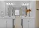 Modern bathroom with double vanity and lots of light at 29027 Picana Ln, Wesley Chapel, FL 33543