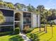 Condo building exterior with balconies and lush landscaping at 3101 Lake Pine Way # H3, Tarpon Springs, FL 34688