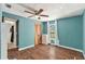 Bedroom with teal walls, wood floors and ceiling fan at 3419 Machado St, Tampa, FL 33605