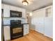 Modern kitchen with black appliances and white cabinets at 3419 Machado St, Tampa, FL 33605