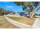 Gray exterior ranch home with teal accents and large tree in the yard at 3515 King Richard Ct, Seffner, FL 33584