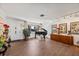 Living room with hardwood floors, grand piano, and stylish decor at 4921 W San Rafael St, Tampa, FL 33629