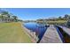 Private wooden dock extends over calm water, offering convenient boat access at 5407 Tybee Island Dr, Apollo Beach, FL 33572