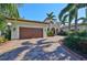 Mediterranean home with a paver driveway, mature landscaping and an attached two-car garage at 5407 Tybee Island Dr, Apollo Beach, FL 33572