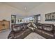 Cozy living room with leather seating, overlooking the pool area through large sliding glass doors at 5407 Tybee Island Dr, Apollo Beach, FL 33572