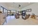 Spacious living room featuring tile flooring, leather furniture, and sliding glass doors to the outdoor living area at 5407 Tybee Island Dr, Apollo Beach, FL 33572