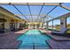 Outdoor pool with a screened-in enclosure and a sunbathing area at 5407 Tybee Island Dr, Apollo Beach, FL 33572